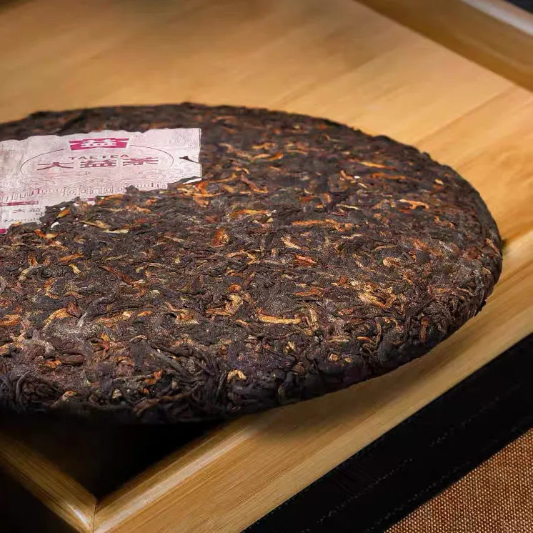 Broken piece of Chun Pin ripe pu-erh cake showing dark pressed leaves