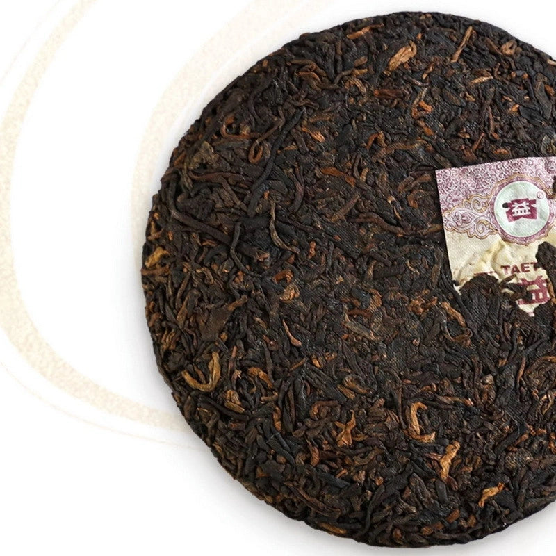Wu Kong ripe pu-erh cake by Dayi showing dark aged pressed leaves, 100g